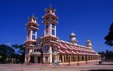 The Holy See of the Cao Dai is in the Vietnamese province of Tay Ninh, close to the Cambodian frontier, and this syncretic religion – which counts Victor Hugo, Laozi and Jesus among its saints – has also made some Khmer converts.<br/><br/>

Vietnam has two indigenous religious sects, both of which were established in the 20th century, and both of which are based firmly in the south of the country. Cao Dai or ‘Supreme Altar’ is a syncretic faith combining aspects of the tam giao with Catholicism and is the larger of the two, with an estimated 2 million followers. Cao Dai is an eclectic amalgam of Confucianism, Taoism, Buddhism and Catholicism. The second sect, called Hoa Hao or ‘Peace and Happiness’, is centred on Chau Doc in the Mekong Delta. Its followers practise an ascetic and austere form of Buddhism.<br/><br/>

The Cao Dai religion was founded in 1919 by a Vietnamese civil servant, Ngo Van Chieu and by the mid-1920s Tay Ninh had developed as the ‘Holy See’ of the new religion, with a hierarchy organised under a Cao Dai pope. Initially persecuted by the communists, Cao Dai is now tolerated, and has an estimated two million followers, mainly in the south.
